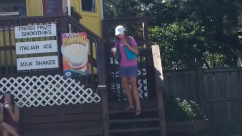 Girl in pink wearing blue life vest