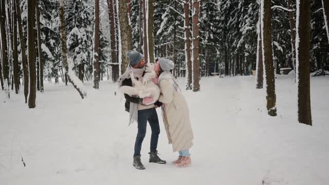 Cute Dog In Snow With Man And Women