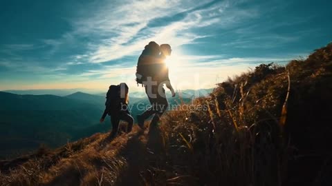 The couple with camping backpacks walking to the mountain top