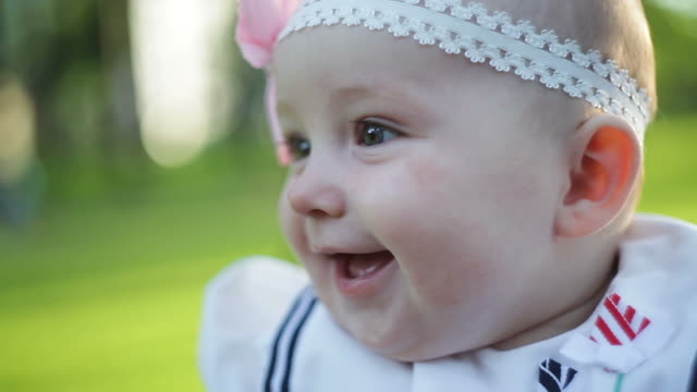 Little Baby Sitting On The Grass