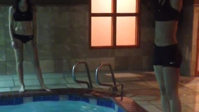 Girl in black dives into water and belly flops instead friend watches