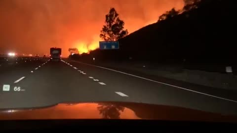 Helicopter Drops Water on Intense Fire