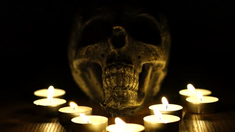 A Skull With Lighted Tea Candles