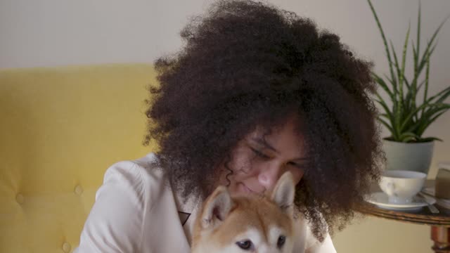 a woman in her pajama taking a selfie photo with her dog