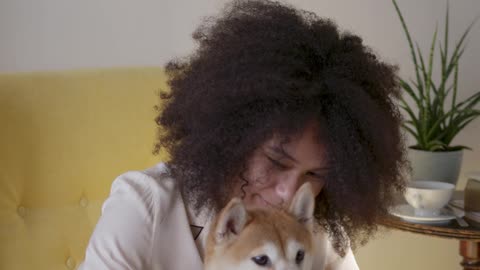 a woman in her pajama taking a selfie photo with her dog