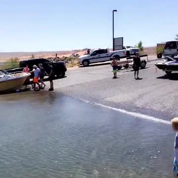 People pushing box into water