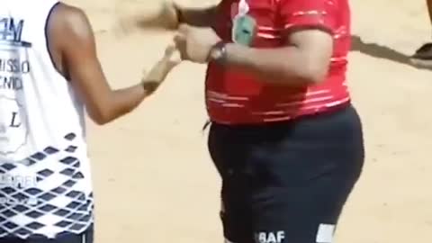 Playing football by the sea