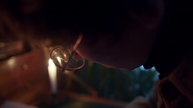 Close Up View of a Man Writing on a Notebook