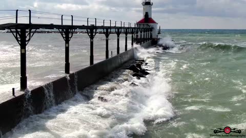RED Flag Massive Waves Slam Into Michigan City Lighthouse 4K Drone Footage