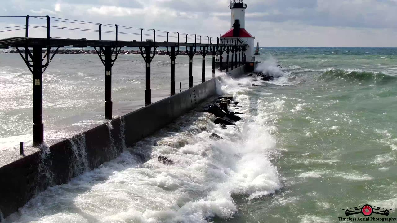 RED Flag Massive Waves Slam Into Michigan City Lighthouse 4K Drone Footage