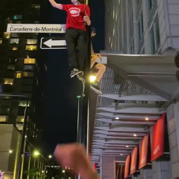 Fans climb light poles after the Habs win Game 6 on June 24