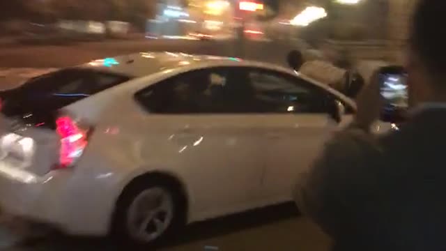 Man rides white car down street