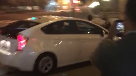 Man rides white car down street