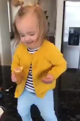 Toddler Girl with Corn Dog Dances