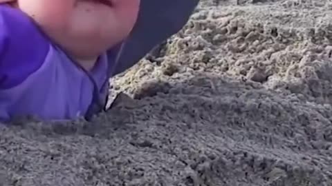 What a funny video of a baby having fun at the beach. #Short