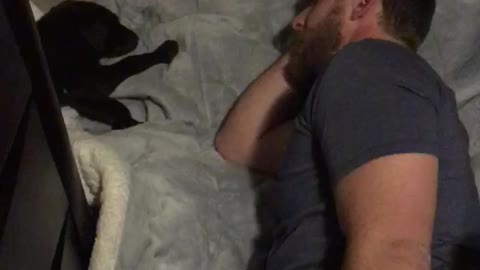 Husband falls asleep on the floor watching his dog sleeping