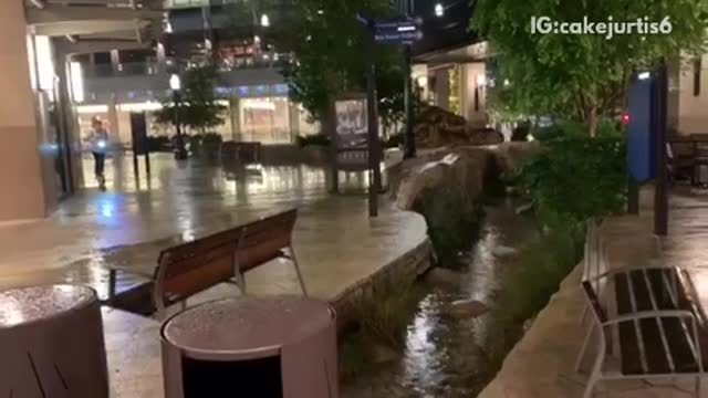 Guy tries to jump over a fountain with an electric scooter, falls into the fountain