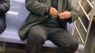 Man clips his fingernails on a subway train