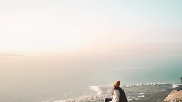 Stop Motion Video of Person Sitting on the Cliff