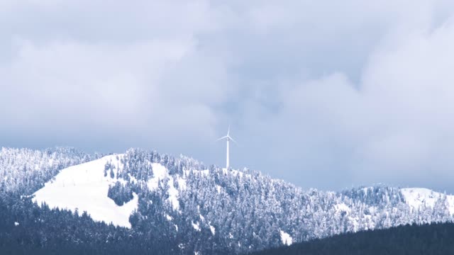 Beautiful Mountain with windmill and covered with freezing snow