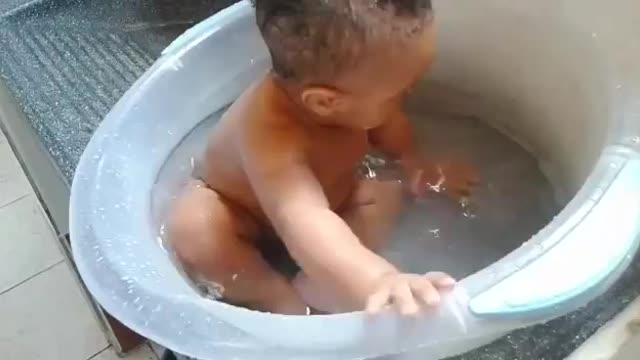 Strong baby playing with water