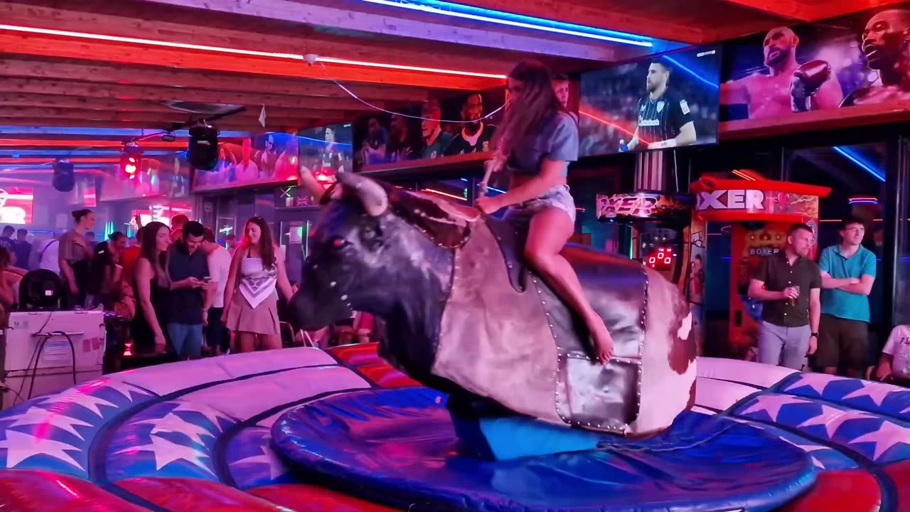 😱 OMG! Pretty Girl Fails at Mechanical Bull Ride in Benidorm | Spain 2024