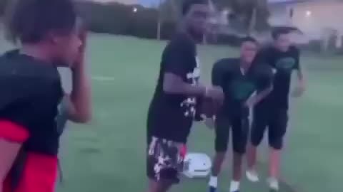 Kodak Black playing football with the youth