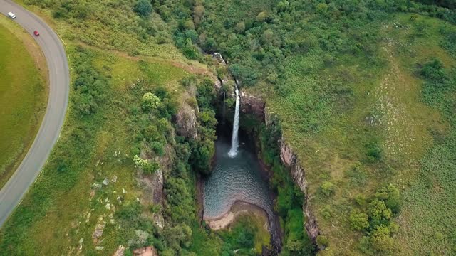 Picturesque Waterfall comes down in a jungle