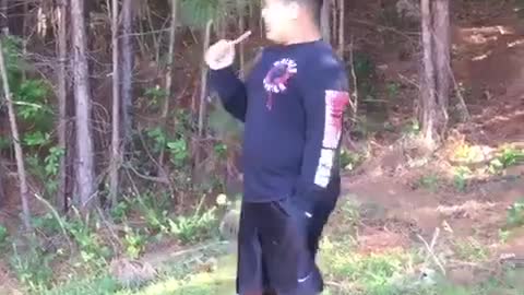 Red sweater kid runs out of woods and falls on face