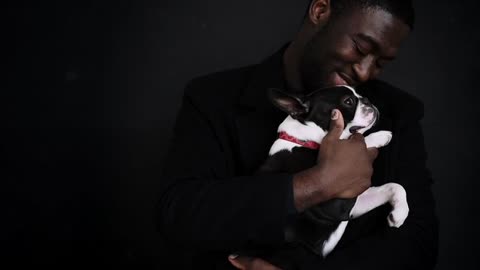 Man Smiling while Caressing His Dog