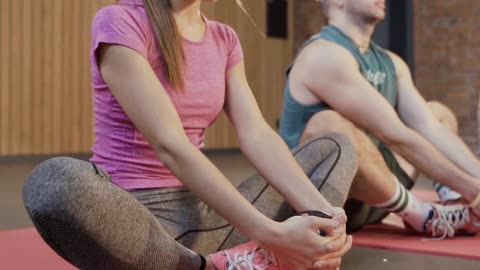 People Stretching on a Mat