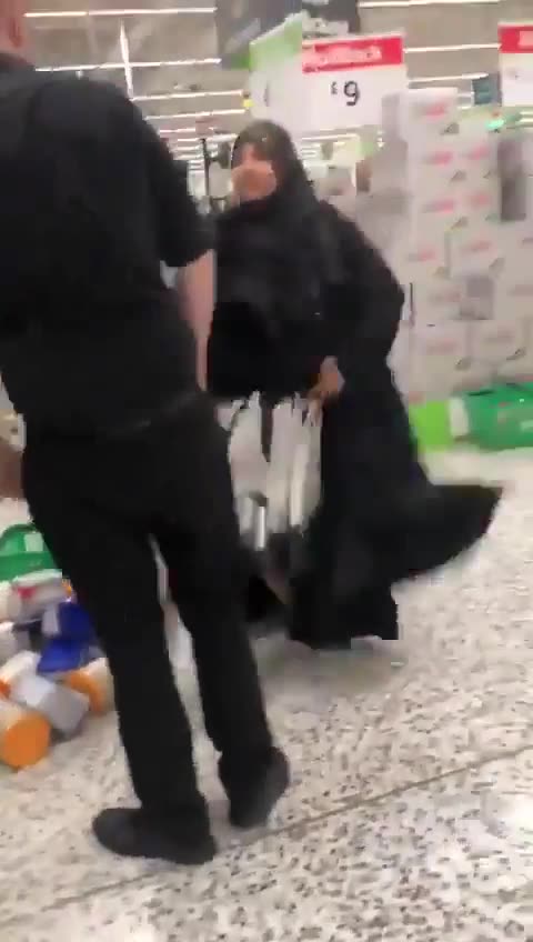 Woman caught using her Burqa to steal food.