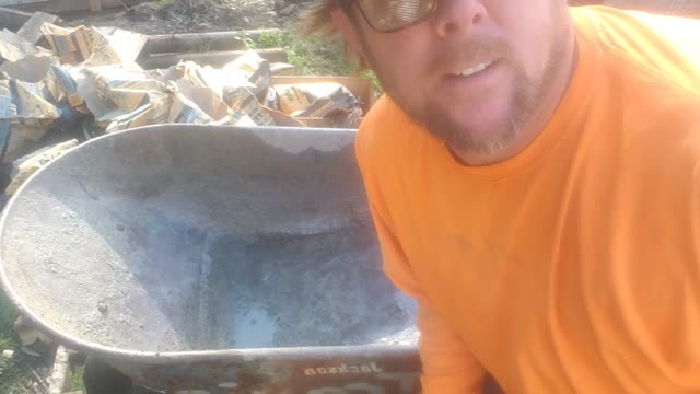 Mixing concrete in a wheelbarrow tips