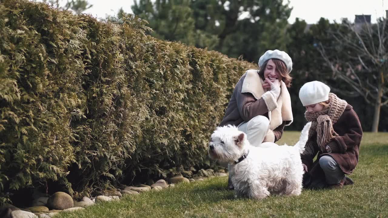 Mother And Child Spending Time Together With Their Dog