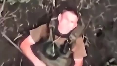 Russian soldier swats away grenade dropped from drine