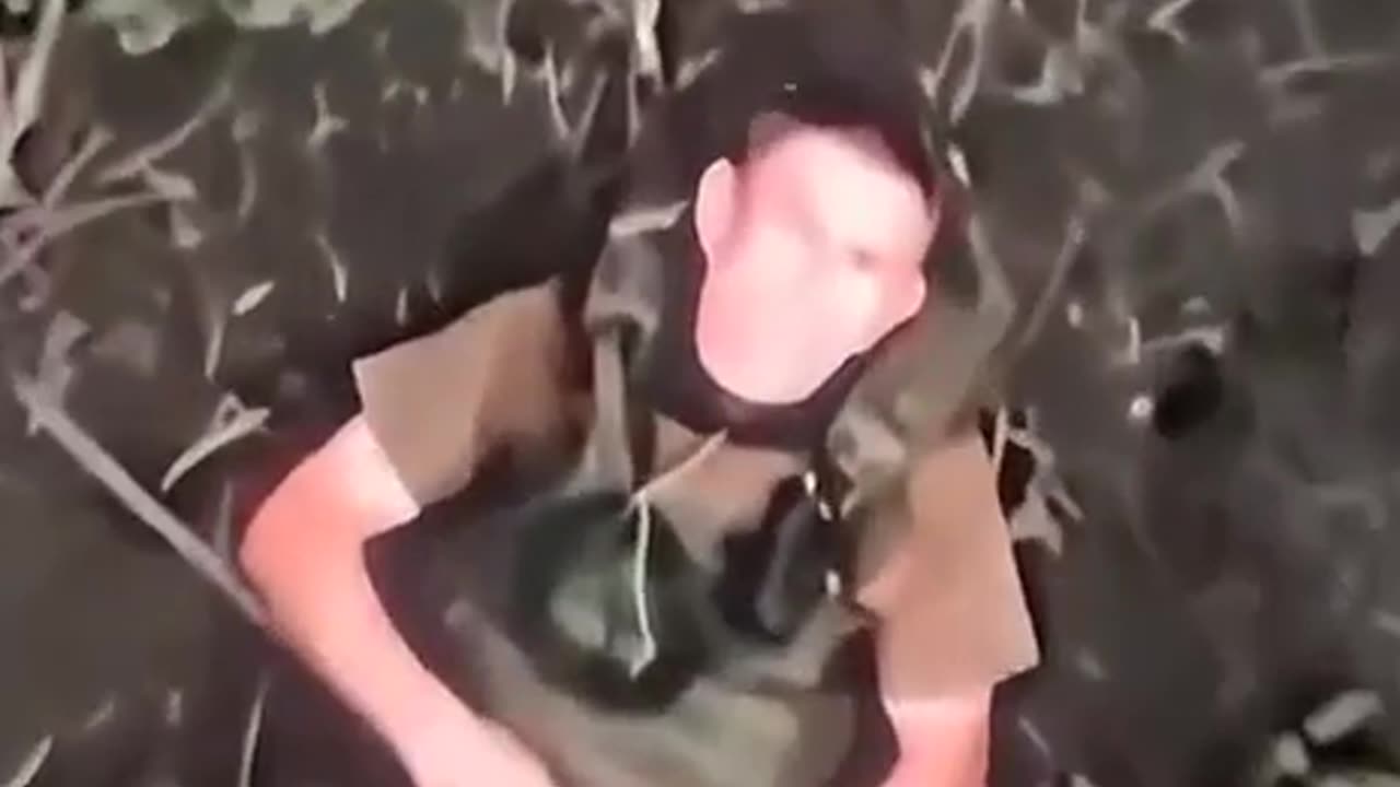 Russian soldier swats away grenade dropped from drine