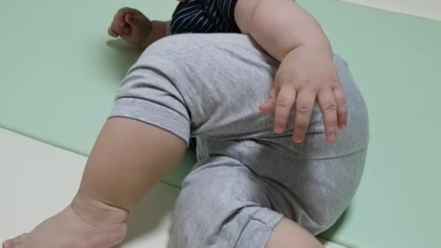 This is a video of a baby practicing crawling using toys.