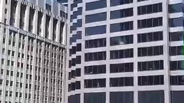 Long distance office building guy dabbing in window