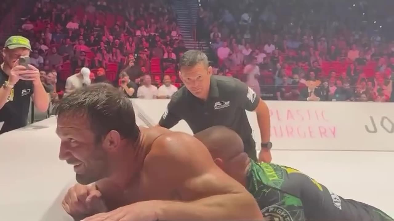 Luke Rockhold Dapping up Demetrious Johnson During His Grappling Match Against Pat Downey