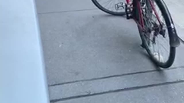 Man fishes through subway grate on the ground