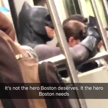 Man dressed as batman on subway train