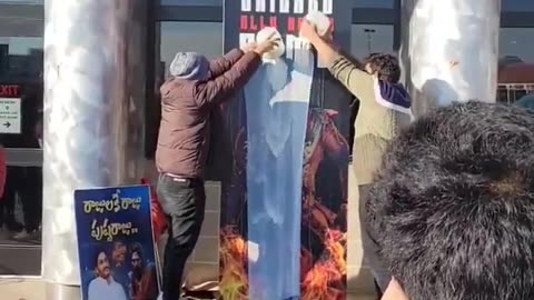 Fans Pouring Milk Over the Cutout Poster of Pushpa 2 Outside a Movie Theatre in Chicago, USA