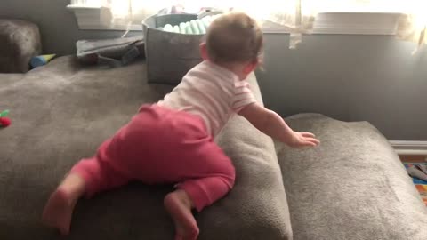 Checking outside and learning to crawl off couch