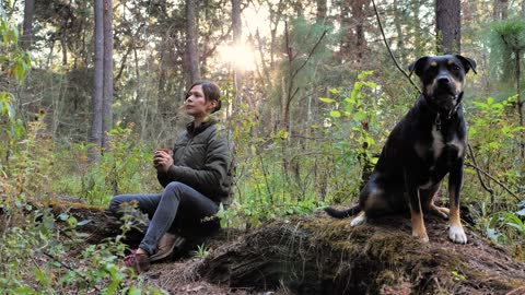 Woman and her dog in a forest