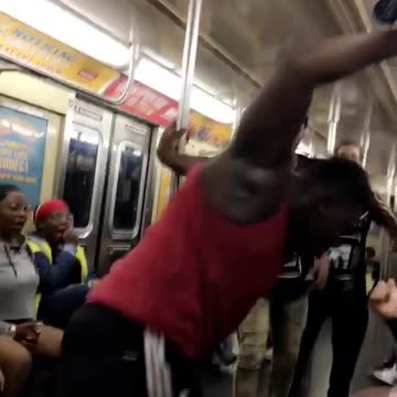 Red tank top man does backflip on subway and clapping crowd screams