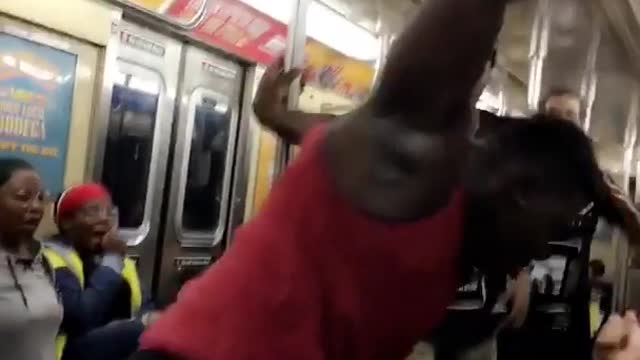Red tank top man does backflip on subway and clapping crowd screams