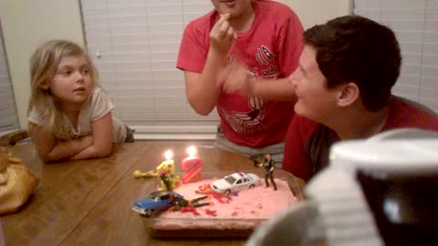 Boy Puts Out His Birthday Candles With His Fingers