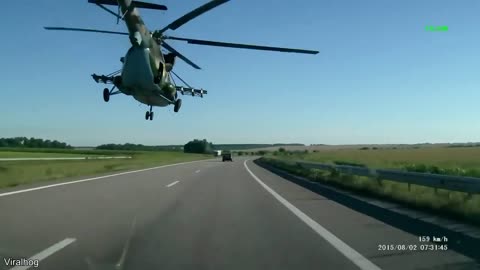 These people were driving on a road in russia when a helicopter started flying right over them