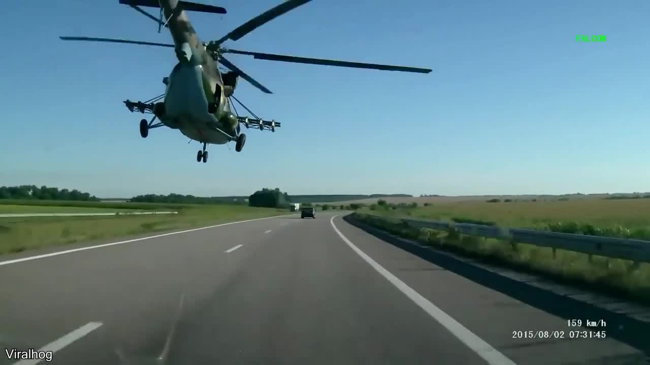 These people were driving on a road in russia when a helicopter started flying right over them