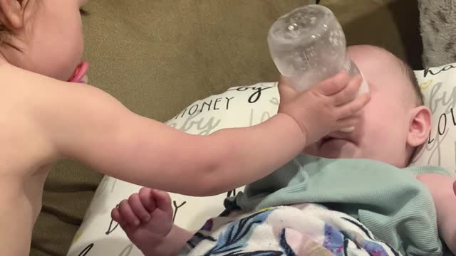 Big Sister Sends Bottle at Baby